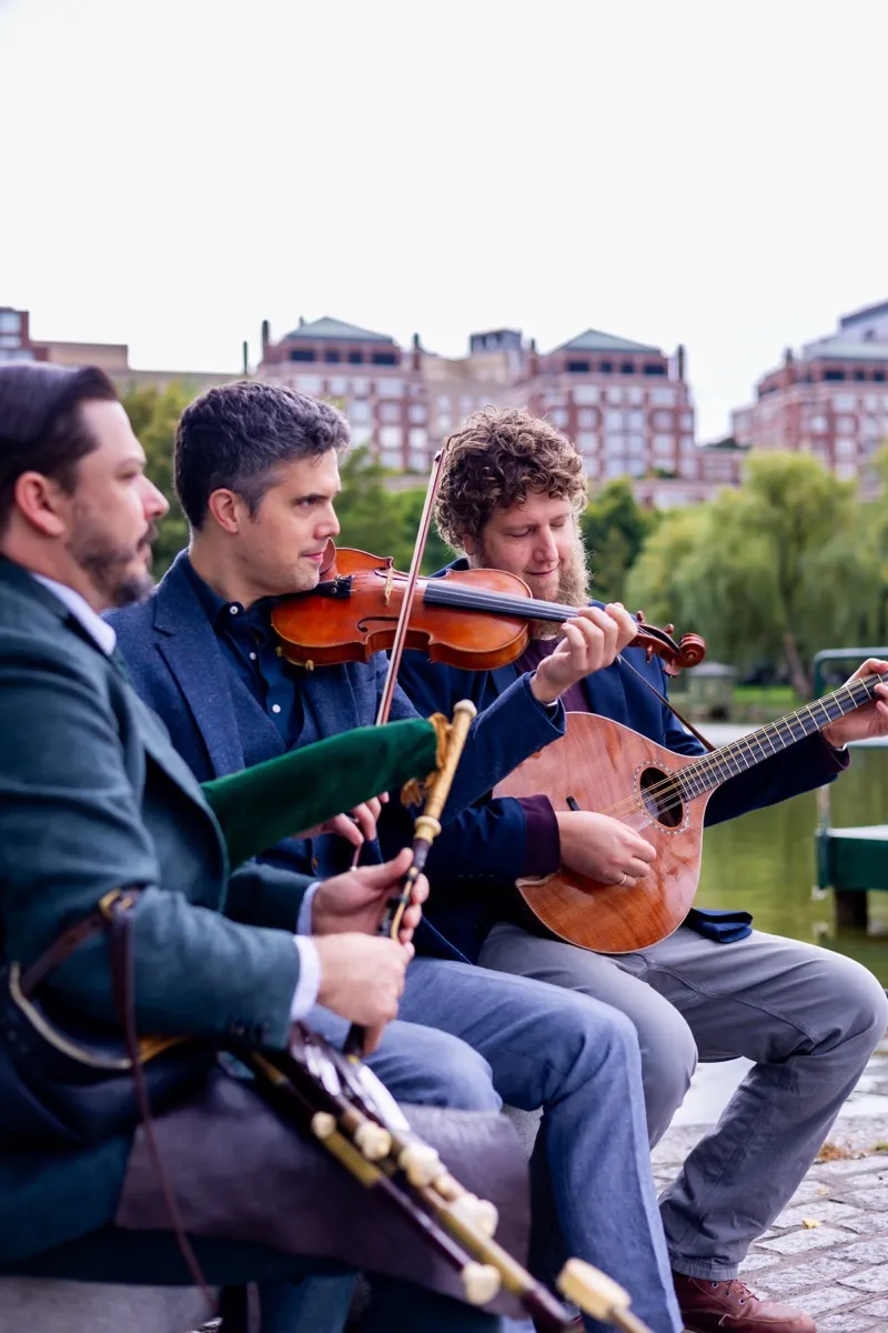 Joey Abarta, Nathan Gourley, and Owen Marshall playing by the water in the Boston Public Garden