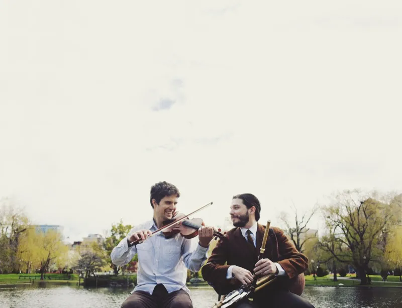 Nathan Gourley and Joey Abarta playing by the water in Boston Public Garden